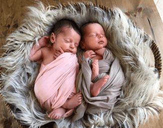 twin baby girls on a furry blanket